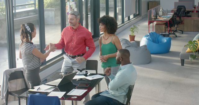 Diverse business team meeting and shaking hands in modern office - Download Free Stock Images Pikwizard.com