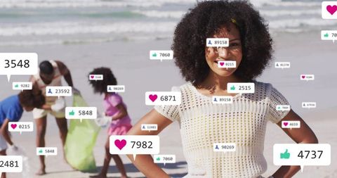 Smiling girl hands-on-hips leading beach cleanup with social media reactions overlay