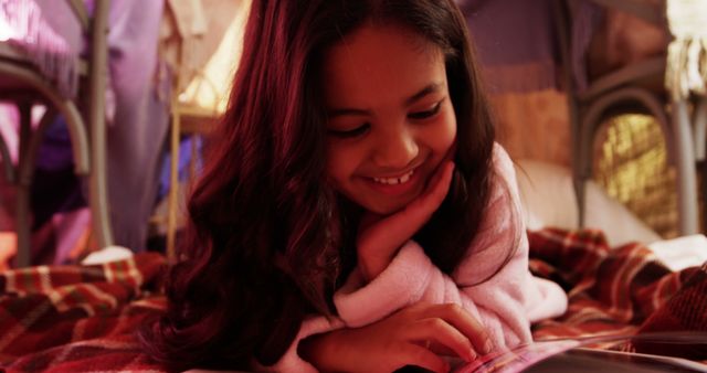 Girl Smiling While Reading: Cozy Indoor Camping Night - Download Free Stock Images Pikwizard.com