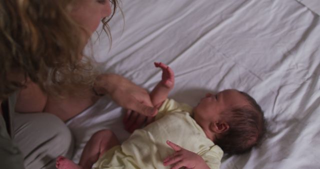 Mother Bonding with Newborn Baby Lying on Bed - Download Free Stock Images Pikwizard.com