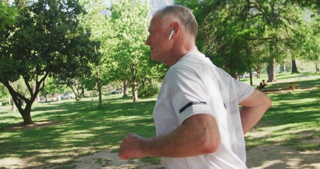 Senior Man Jogging in Park with Earbuds - Download Free Stock Images Pikwizard.com