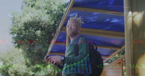 Urban commuter viewing financial charts on smartphone at bus stop