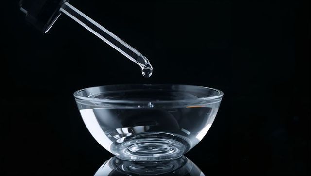 Droplet from Pipette into Glass Bowl on Reflective Surface