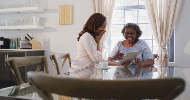 Happy Grandmother and Granddaughter Using Digital Tablet Together at Home - Download Free Stock Images Pikwizard.com