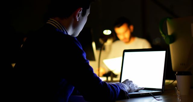 Focused Man Working on Laptop in Dull Office at Night - Download Free Stock Images Pikwizard.com