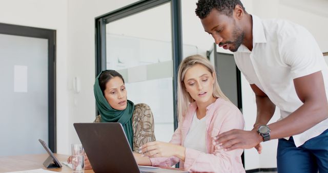 Diverse Team Collaborating on Laptop During Office Meeting - Download Free Stock Images Pikwizard.com