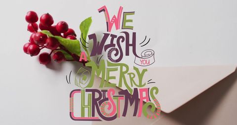 Christmas Card with Festive Text and Red Berries on Grey Surface - Download Free Stock Images Pikwizard.com