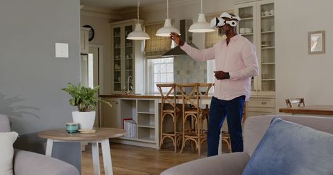 Senior Man Engaging with Virtual Reality in Modern Kitchen