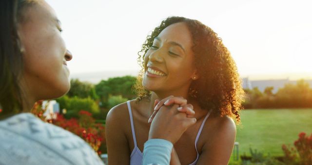 Two Women Smiling and Holding Hands in Nature Setting - Download Free Stock Images Pikwizard.com