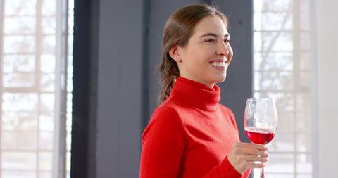 Woman Enjoying Wine in Bright Modern Setting