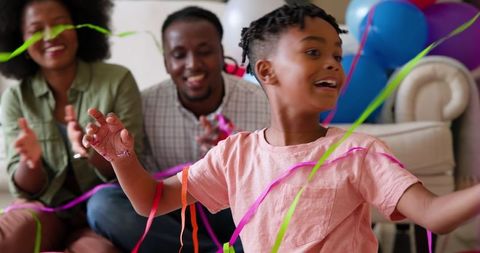Joyful Family Celebrating Son's Birthday with Confetti
