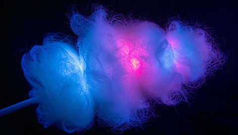 Glowing cotton candy pulsing blue and pink LED lights on stick against dark background