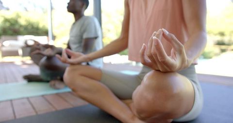 Diverse Couple Practicing Meditation Outdoors in Tranquil Setting