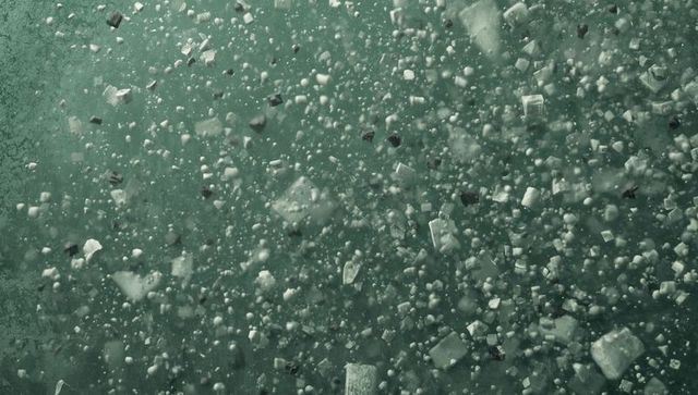 Floating microplastic fragments in murky green fluid affects aquatic environment
