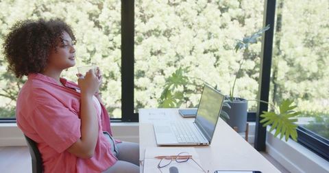 Woman Enjoying Coffee Break in Bright Home Office