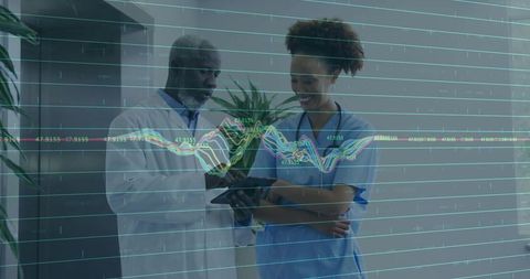 Doctors Analyzing Digital Patient Data on Tablet with Graph Overlay