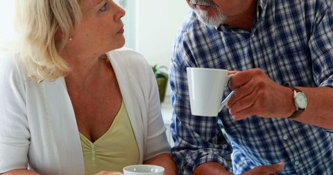 Middle-Aged Couple Engaging in Relaxed Coffee Conversation - Download Free Stock Images Pikwizard.com