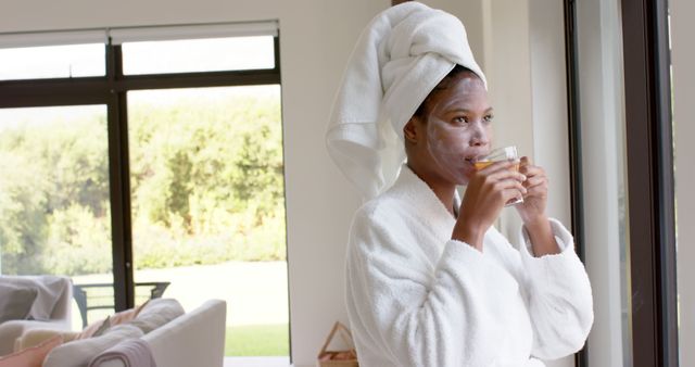 Woman Relaxing at Home in Bathrobe with Face Mask - Download Free Stock Images Pikwizard.com