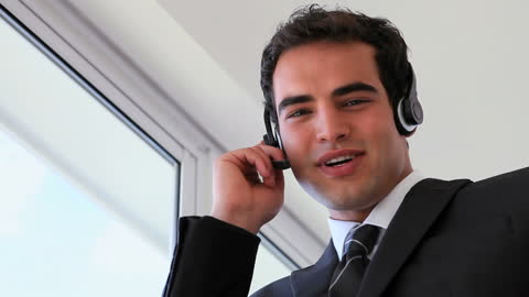 Confident Businessman in Suit Using Headset
