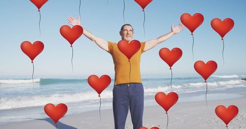 Senior Man Enjoying Red Heart Balloons on Beach - Download Free Stock Images Pikwizard.com