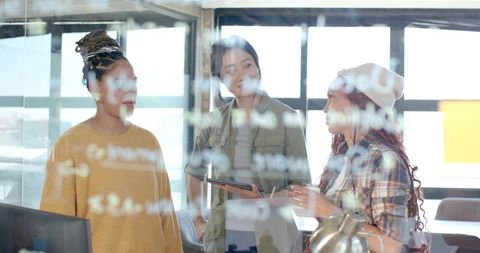 Diverse Team Collaborating in Modern Office around Glass Board