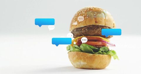 Cheeseburger with floating chat bubbles in minimalist setting