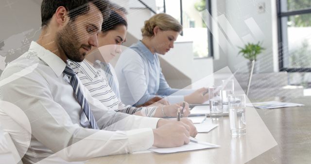 Business Professionals Sitting at Desk Taking Notes in Meeting - Download Free Stock Images Pikwizard.com