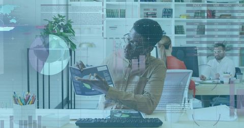 African American Businessman Analyzing Financial Data Overlay in Modern Office