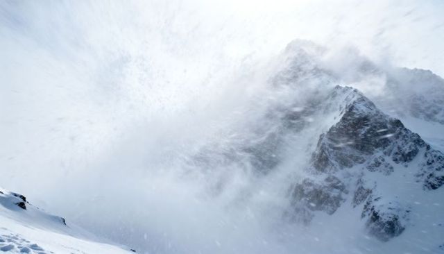 High-Altitude Blizzard Swirling Around Jagged Alpine Ridge with Drifting Cornices