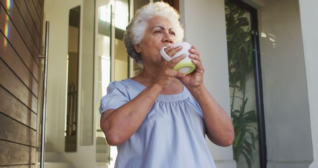 Senior woman enjoying morning coffee on house porch - Download Free Stock Images Pikwizard.com