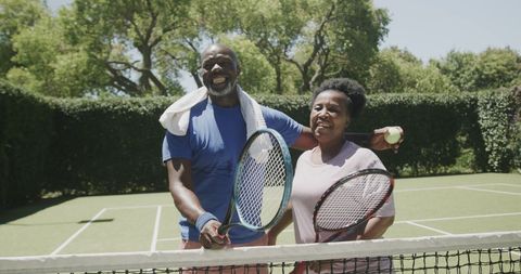 Happy Senior Couple Enjoys Tennis Court Leisure