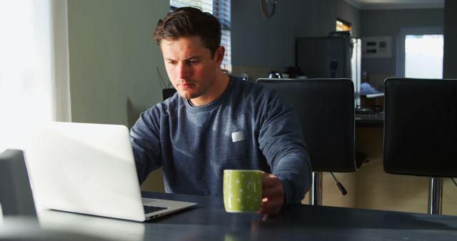 Focused man in casual outfit working from home with laptop - Download Free Stock Images Pikwizard.com