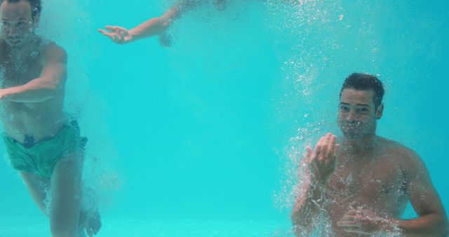 Friends underwater in swimming pool 