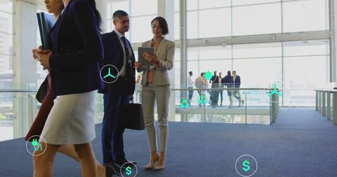 Corporate professionals discussing sustainable finance in atrium