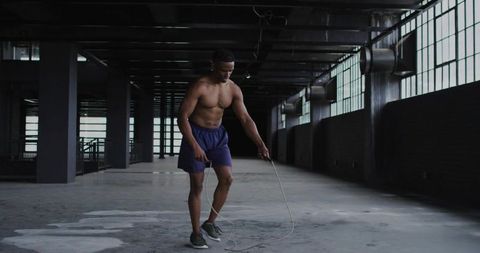 Athlete Skipping Rope in Urban Warehouse Environment
