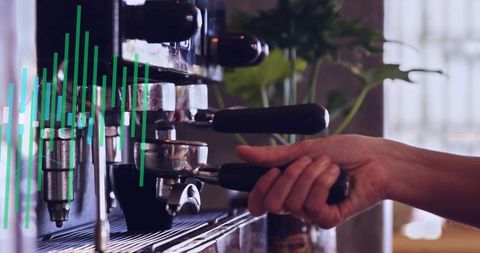 Barista locking portafilter into commercial espresso machine with green data overlay