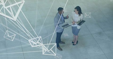 Business Colleagues Collaborating Reviewing Documents with Digital Email Network Overlay