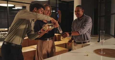 Colleagues celebrating success with champagne in office lounge