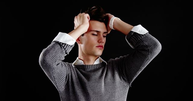 Worried Young Man Holding Head Against Black Background - Download Free Stock Images Pikwizard.com