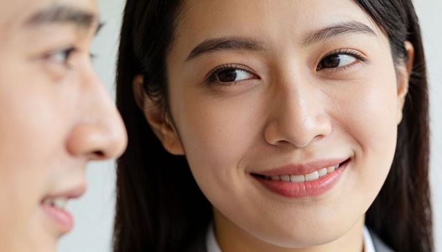 Smiling businesswoman making eye contact during corporate conversation closeup portrait