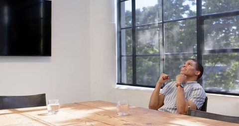 Overjoyed businessman celebrating success in bright office
