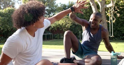 Men High-Fiving Post Workout Outdoors
