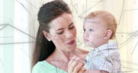Loving Mother Holding Curious Infant by Sunlit Window