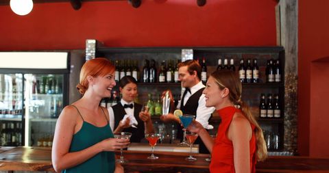 Two Women Enjoying Cocktails Conversing at Stylish Bar - Download Free Stock Images Pikwizard.com