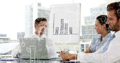 Business team presenting data and brainstorming strategy in modern glass boardroom