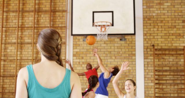 Female basketball coach observing team practice in gym - Download Free Stock Images Pikwizard.com