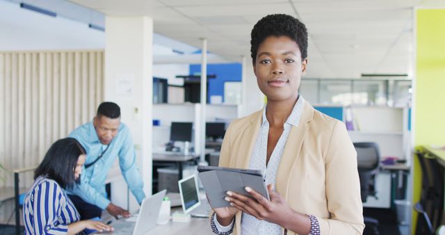 Confident Businesswoman Holding Digital Tablet in Modern Office - Download Free Stock Images Pikwizard.com