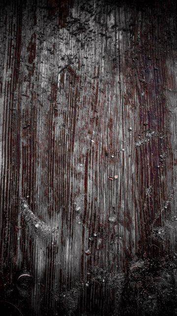 Detailed view of rustic, grungy wooden surface with dark hues and distressed texture. Perfect for use in backgrounds, digital design, and textural overlays to provide a vintage and natural feel. Suitable for adding depth and character to graphic designs, presentations, and printed materials.