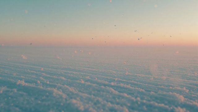 Pastel arctic sunrise over snow-covered plain