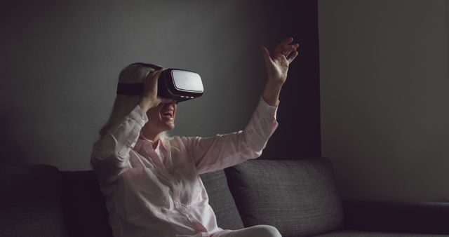 Woman Enjoying Virtual Reality Experience at Home in Dimly Lit Room - Download Free Stock Images Pikwizard.com